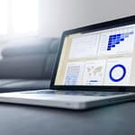 Security analyst reviewing breach data on screens representing the Verizon 2026 Data Breach Investigations Report findings on vulnerability exploitation and ransomware